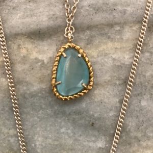 3 tiered gold pendant necklace with aquamarine gemstone